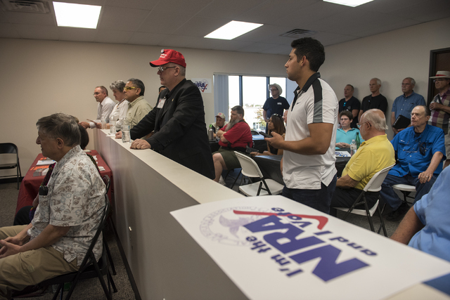 Volunteers and attendees listen to Robert Uithoven, NRA Nevadans for Freedom campaign manager, during the grand opening for a National Rifle Association campaign office at 6375 S. Pecos Road in La ...