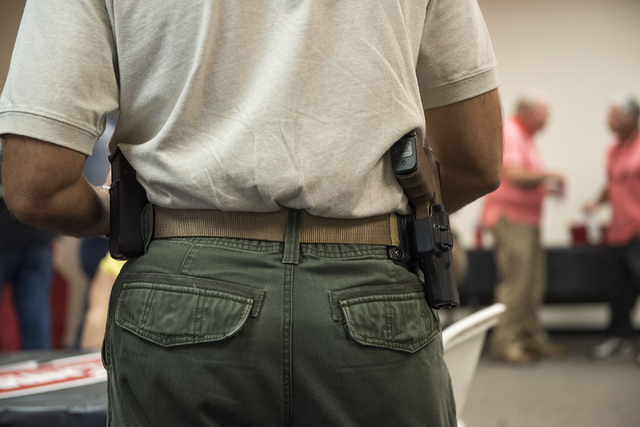 An attendee with an open carry firearm is shown during the grand opening for an NRA Nevadans for Freedom campaign office at 6375 S. Pecos Road in Las Vegas, Tuesday, Aug. 9, 2016. Martin S. Fuente ...