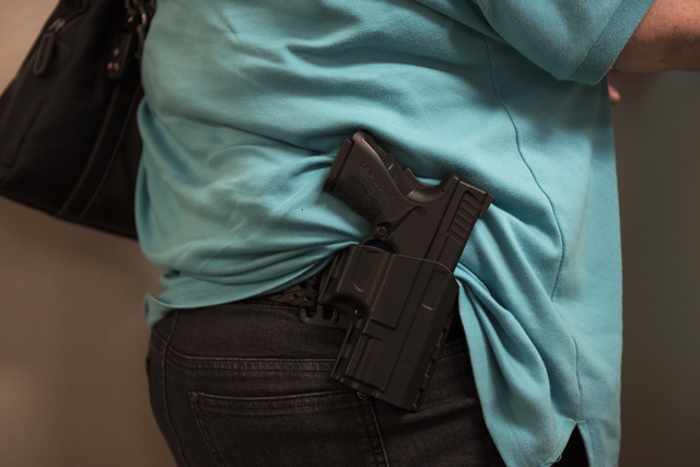 An attendee with an open carry firearm is shown during the grand opening for an NRA Nevadans for Freedom campaign office at 6375 S. Pecos Road in Las Vegas, Tuesday, Aug. 9, 2016. Martin S. Fuente ...