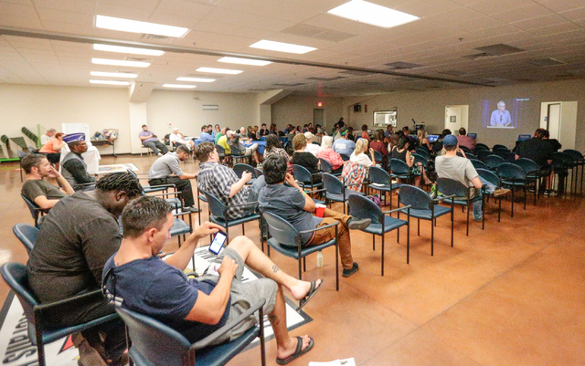 Attendees watch a live stream video by former Democratic presidential candidate and Sen. Bernie Sanders at the "Our Revolution" kickoff party held at the Veterans of Foreign Wars ...