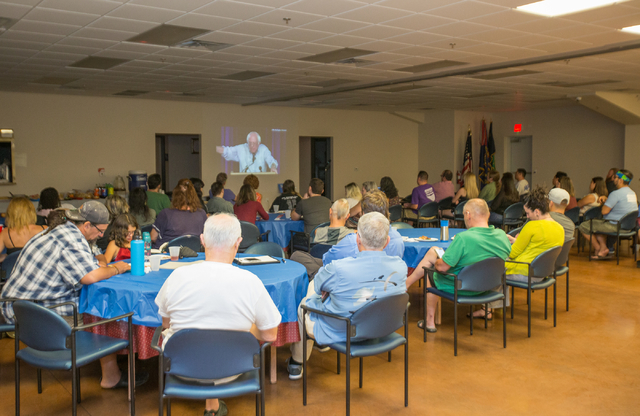 Attendees watch a live stream video by former Democratic presidential candidate and Sen. Bernie Sanders at the &quot;Our Revolution&quot; kickoff party held at the Veterans of Foreign Wars ...