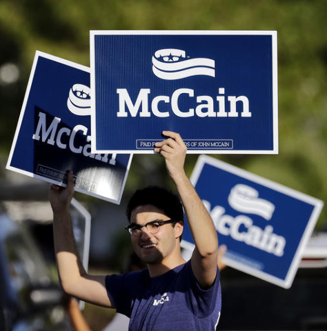 U.S. Sen. John McCain supporters stand outside a polling station, Tuesday, Aug. 30, 2016, in Phoenix. McCain is seeking the republican nomination in Arizona's primary election. (AP Photo/Matt York)