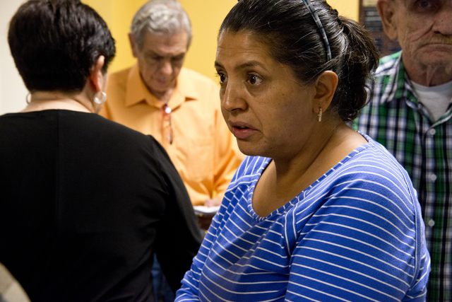 Carmen Morales speaks with other homeowners affected by Summerlin Energy's bankruptcy after a meeting of the Nevada State Contractors Board at their offices in Henderson on Thursday, Aug. 4, 2016. ...