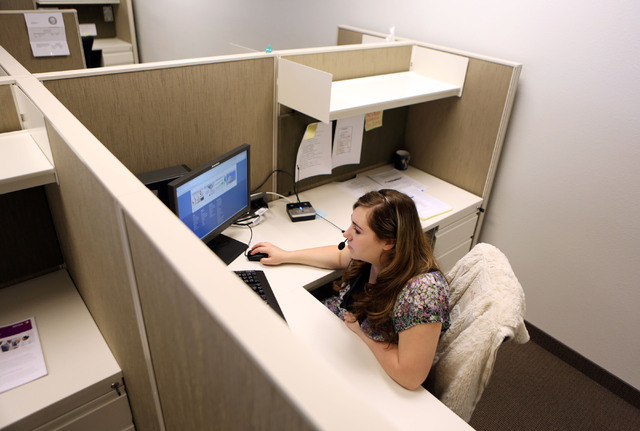 Amanda Schlichtenmyer looks through Nevada Health Link training materials in between taking calls at Siler State Health Insurance Exchange call center Tuesday, Sept. 24, 2013, in Henderson. Staff ...