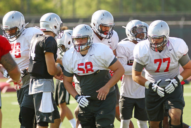 UNLV's 1st string offensive linemen Justin Polu (78), Will Kreitler (58) and Michael Chevalier (77) participate in a drill during football practice at UNLV Monday, Aug. 8, 2016, in Las Vegas. (Ron ...