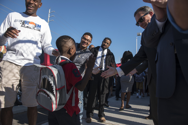 A student is greeted by over 100 male role models on the first day of school at Matt Kelly Elementary School in Las Vegas on Monday, Aug. 29, 2016. Nevada Youth Network recruited over 100 male rol ...