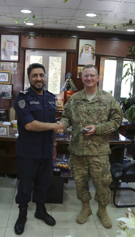 Col. Vernon L. Scarbrough, commander of the 17th Sustainment Brigade, shakes hands with Brig. Gen. Khalid M. Mohammed, the commander of the Kuwaiti Security Forces, during a meeting in Kuwait. (Co ...
