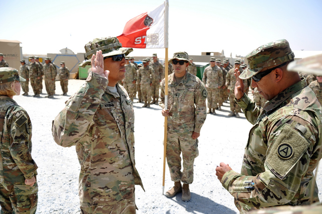 Chief Warrant 2 Jaime Wright, a material manager with the 17th Sustainment Brigade, receives his commission after receiving a promotion on June 4, 2016, in Camp Arifjan, Kuwait. (Courtesy/Staff Sg ...