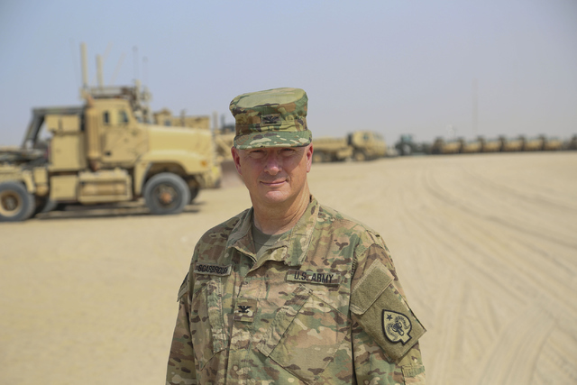 Col. Vernon L. Scarbrough, commander of the 17th Sustainment Brigade, stands among some of the logistics vehicles used in Camp Arifjan, Kuwait on June 30, 2016. (Courtesy/Staff Sgt. Victor Joecks, ...