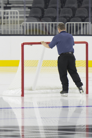 A crew member glides a goal into place prior to allowing members of the Storm Youth Hockey organization skate on the newly installed ice at T-Mobile Arena in Las Vegas Wednesday, Aug. 3, 2016. Jas ...