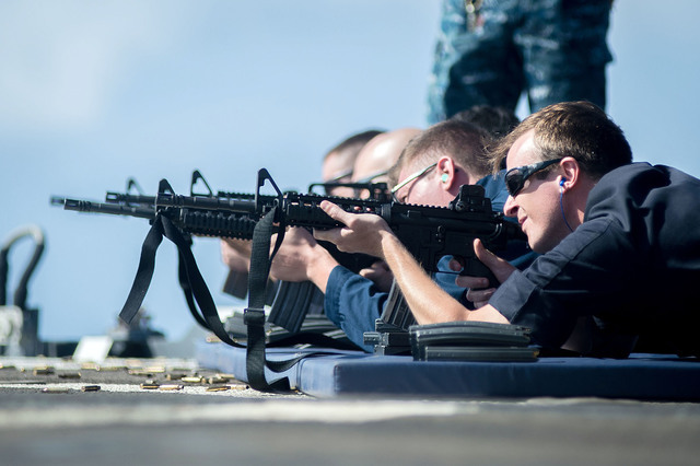 Operations Specialist Seaman Justin Lund of Las Vegas, qualifies with the M-4 rifle during a small-arms gun shoot June 25, 2016, aboard the guided-missile cruiser USS Mobile Bay (CG 53). U.S. Navy ...