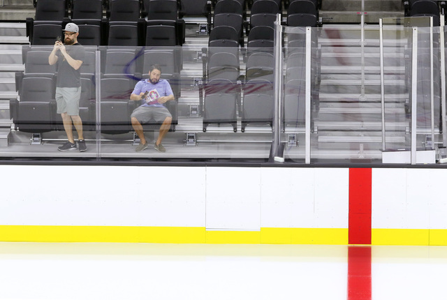 Joe Hulbert, left, takes video of the ice and Rich Belsky looks at a pamphlet near center ice during an open house for prospective 2017 Vegas NHL hockey season ticket holders at T-Mobile Arena Mon ...