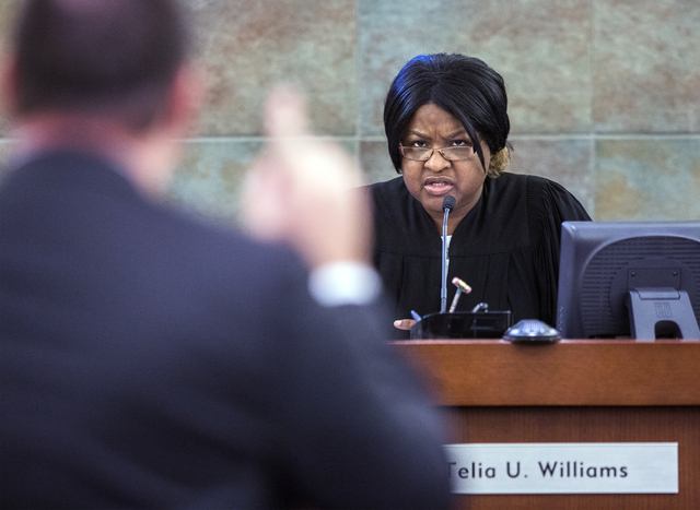 Justice of the Peace Telia Williams,right, listens while defense attorney Adam Gill makes a point during arguments in a bail hearing for London Lacy, a former football player at the University of  ...