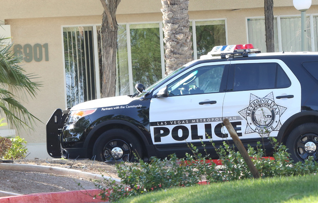 A police car is seen at Avion apartment complex on 6901 E. Lake Mead Blvd., near Hollywood Boulevard, on Tuesday, Aug. 9, 2016. A man was found inside an apartment near the complex pool area with  ...
