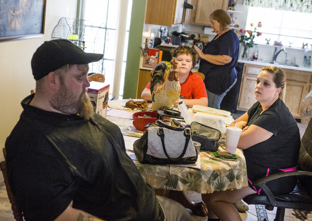 Stanley Furrow Jr., 33, left, sits in the family's dining room with nephew Joseph, 13, mother, Linda, and sister, Jolie, 32, on Thursday, Aug. 11, 2016.The family claims their health issues are ca ...