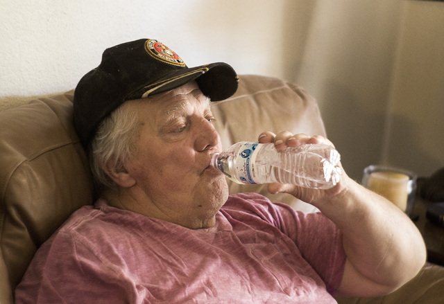 Marine veteran Stanley Furrow drinks a bottle of water in the family's home in Las Vegas on Thursday, Aug. 11, 2016. The family claims their health issues are cause by water laced with solvents at ...