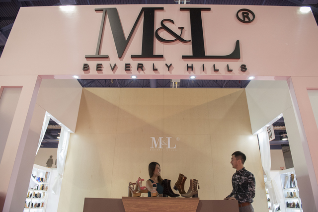 Designer Mackin Jiang of M&L Beverly Hills, right, speaks to sales representative Teresa Yu at the MAGIC trade show inside the Las Vegas Convention Center on Monday, Aug. 15, 2016. Martin S. F ...