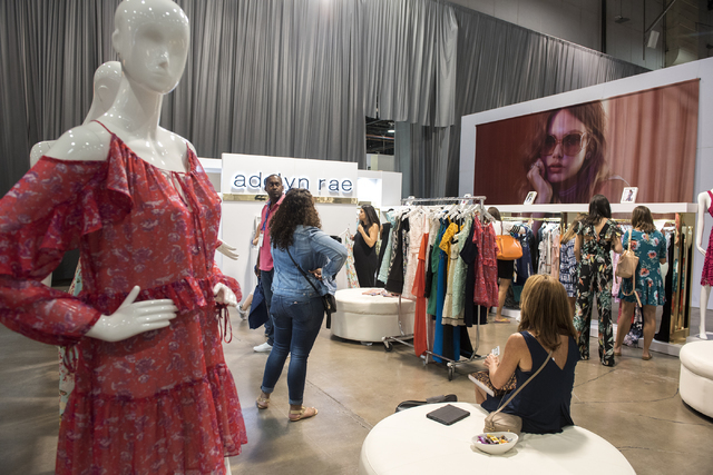 Attendees look through Adelyn Rae's clothing during the MAGIC trade show inside the Las Vegas Convention Center on Monday, Aug.15, 2016. Martin S. Fuentes/Las Vegas Review-Journal
