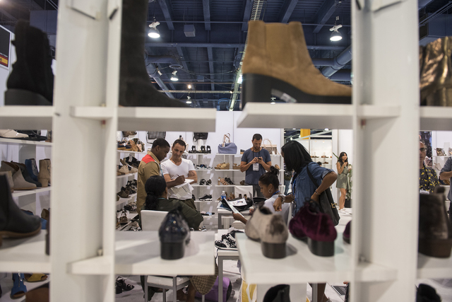 Attendees looks at shoes in the MTNG booth during the MAGIC trade show inside the Las Vegas Convention Center on Monday, Aug.15, 2016. Martin S. Fuentes/Las Vegas Review-Journal