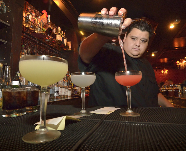 Nectaly Mendoza, owner of Herbs and Rye, mixes drinks in the bar and restaurant at 3713 Sahara Ave. in Las Vegas on Friday, Aug. 12,  2016. (Bill Hughes/Las Vegas Review-Journal)