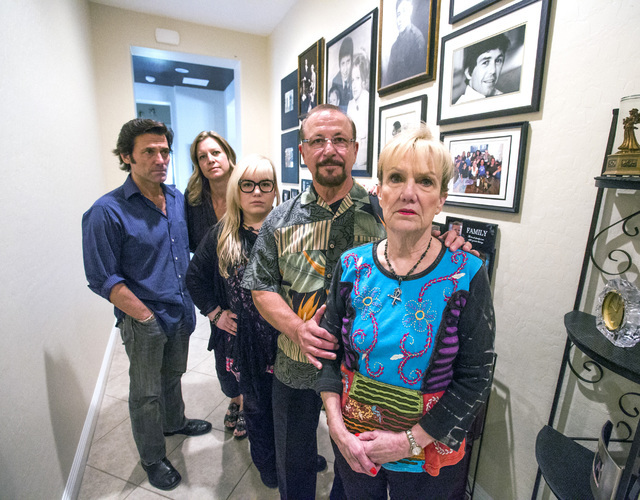 The family of murder victim Jay Sebring stands next to the wall of family portraits in the DiMaria'sHenderson home. On the right is Sebring's sister Peggy DiMaria, flanked by her husband, Tony, an ...