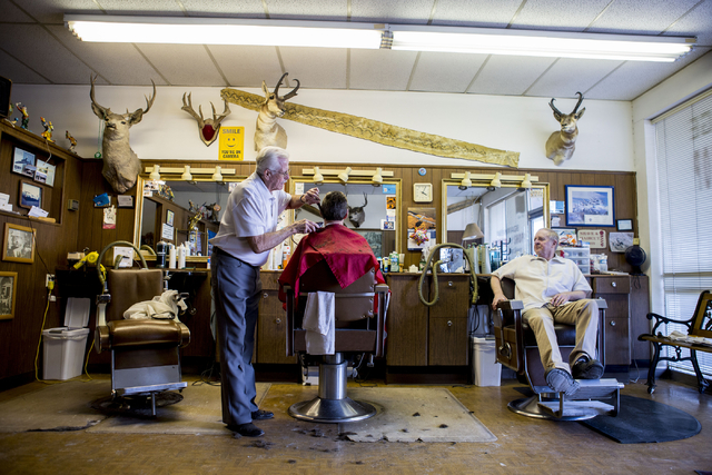 Barber Jon Holten, left, cuts a clients hair at New Image Barber & Styling in Las Vegas, Wednesday, Aug. 17, 2016, as Barber Randy Benefiel looks on. (Elizabeth Page Brumley/Las Vegas Review-J ...