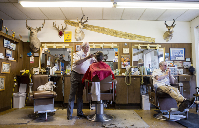 Barber Jon Holten, left, cuts a clients hair at New Image Barber & Styling in Las Vegas, Wednesday, Aug. 17, 2016, as Barber Randy Benefiel takes a break.  (Elizabeth Page Brumley/Las Vegas Re ...