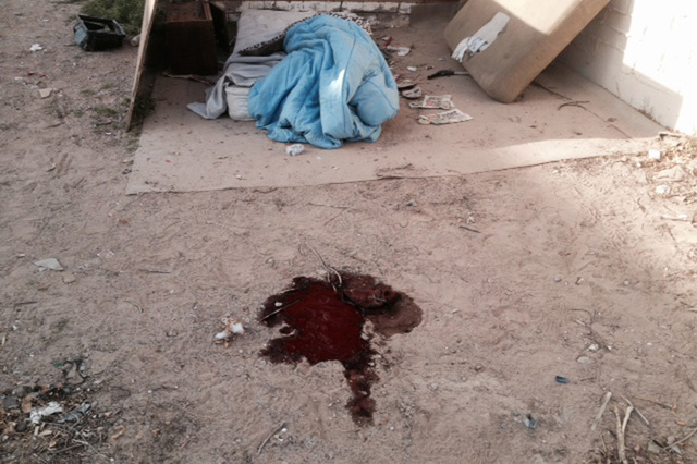 A pool of blood near a makeshift bed is seen Monday, March 10, 2014 behind a building at 800 N. Tonopah after David Robinson was killed in an officer-involved shooting in North Las Vegas. A civil  ...