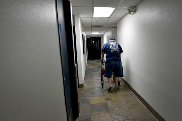 Michael Eshleman, Friends of Parkinson's volunteer and Parkinson patient walks back to an office after sharing his story Thursday, Aug. 18, 2016, in Las Vegas. Friends of Parkinson's will be hosti ...