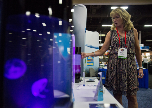 Joleen Turner shows off jellyfish aquariums during the SuperZoo Trade Show at the Mandalay Bay Convention Center on the Las Vegas Strip on Tuesday, Aug. 2, 2016. (Daniel Clark/Las Vegas Review-Jou ...