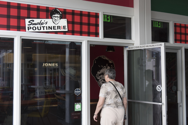 A customer enters Smoke's Poutinerie at Pawn Plaza in Las Vegas Friday, July 8, 2016. (Jason Ogulnik/Las Vegas Review-Journal)
