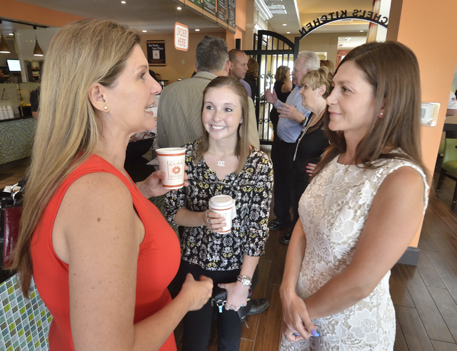 Debbie Roxarzade, founder and CEO of Rachel's Kitchen, right, talks with Laura Porreca, left and Rachel Frazer during a grand opening for the company's latest franchise at the Hilton Garden Inn at ...