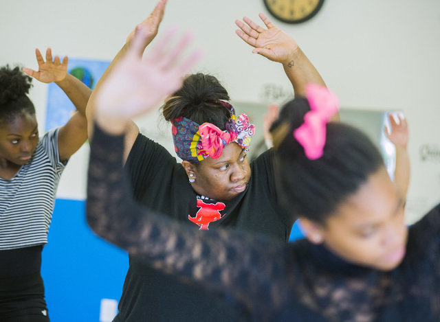 Aleisha Hall, center, participates in a contemporary dance class at Studio 305, the new home of former Cirque du Soleil dancer Tyler Rolle's R.A.G.E. (Reaching Above Greater Expectations) program ...