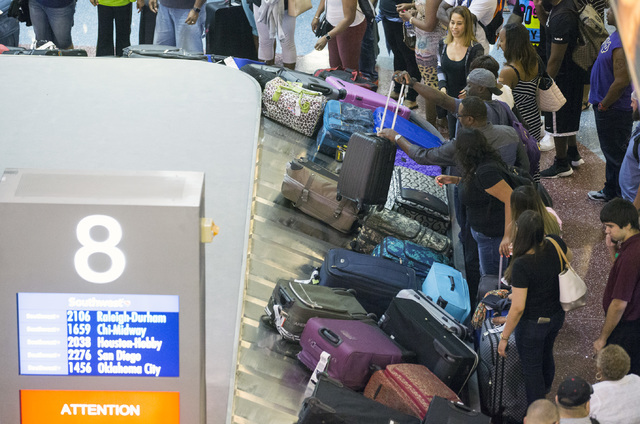 People pick up bags at the Southwest Airline baggage carousel Thursday, July 21, 2016, at McCarran International Airport. (Jeff Scheid/Las Vegas Review-Journal) Follow @jeffscheid