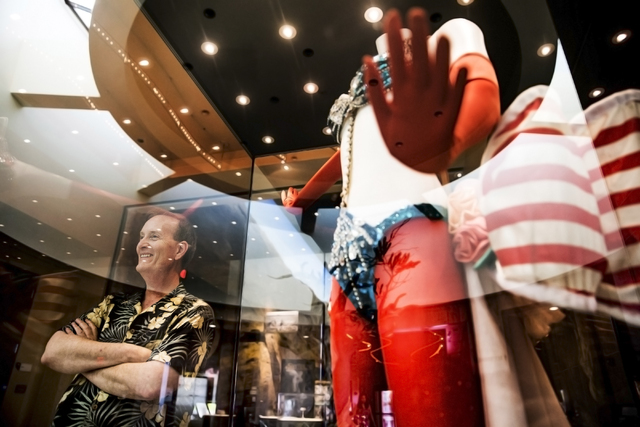 Flanked by "Folies Bergere" costume display, museum director Dennis McBride surveys the lobby of the Nevada State Museum, Las Vegas. (Benjamin Hager/Las Vegas Review-Journal)