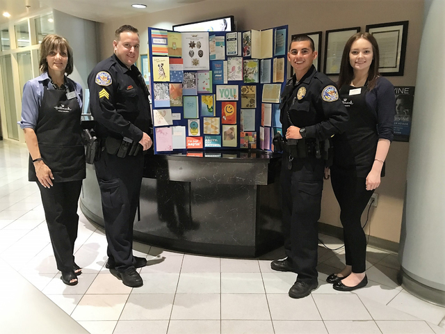 Officers and Hallmark employees show off cards during the store's Thank Our Blue program event at 1445 W. Sunset Road, which collected more than 700 cards in early August 2016. Special to View