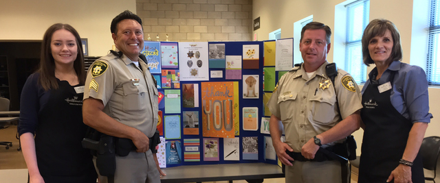 Officers and Hallmark employees show off cards during the store's Thank Our Blue program event at 1445 W. Sunset Road, which collected more than 700 cards in early August 2016. Special to View