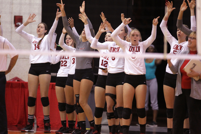 Members of the UNLV women's volleyball team celebrate winning a long rally in the second set against Fresno State at Cox Pavilion in Las Vegas Thursday, Sept. 25, 2014. UNLV went on to beat Fresno ...