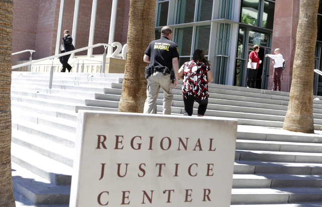 A Clark County marshal and a woman arrive at the Regional Justice Center on 200 Lewis Ave., on Tuesday, Aug. 16, 2016, in Las Vegas. (Bizuayehu Tesfaye/Las Vegas Review-Journal) Follow @bizutesfaye