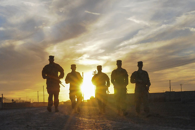 A group of soldiers walk along the road at sunset in Taji, Iraq earlier this year. With summer temperatures reaching over 120 degrees in Iraq and surrounding countries during its 2016 deployment, ...