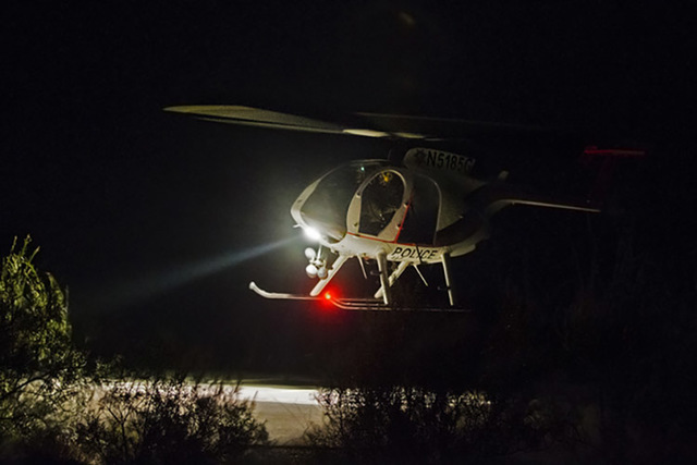 A law enforcement helicopter lands at a helicopter pad to assist with a hikers death at the overlook at Red Rock Canyon National Conservation Area on Thursday, Aug. 25, 2016, in Las Vegas.  (Benja ...