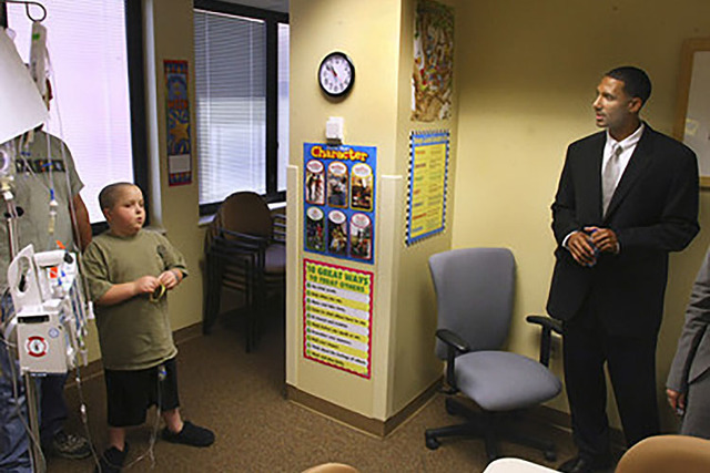 During the grand opening of the Torino Classroom at Sunrise Children's Hospital, 10 year-old leukemia patient Brandon Rayner checks out the new facilities with Lenny Ware, Nevada Childhood Cancer ...