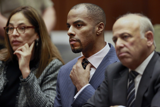 In this March 23, 2015, file photo, former NFL safety Darren Sharper, center, with his attorneys, Lisa Wayne, left, and Leonard Levine, right, appear in Los Angeles Superior Court. Sharper has bee ...