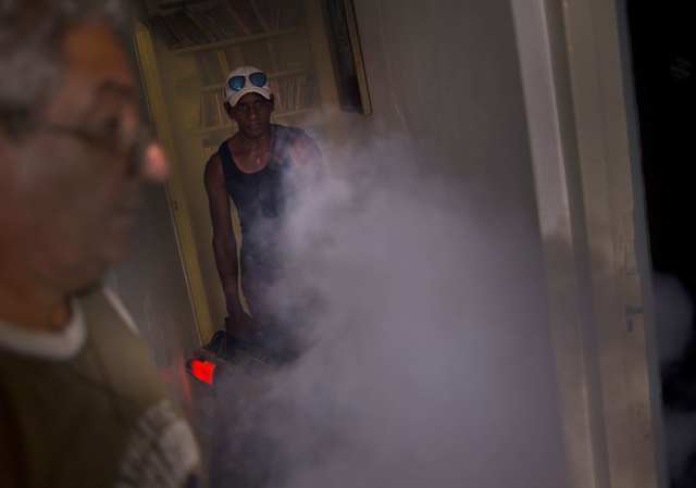 In this Aug. 26, 2016 photo, a government fumigator sprays a home for mosquitos in Havana, Cuba. (Ramon Espinosa/AP)