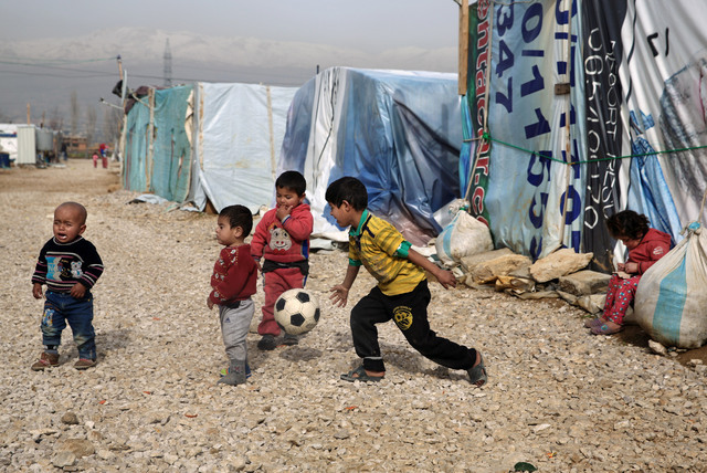 In this Jan. 22, 2016 file photo, Syrian refugee children play outside their family tents in a camp in the town of Saadnayel, in the Bekaa valley, Lebanon. Some 28 million children around the glob ...