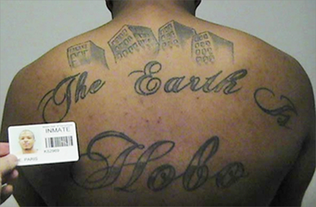 This undated photo in a court filing provided by the U.S. Attorney's office in Chicago, shows Paris Poe's back tattoo that reads 'The Earth Is Our Turf, and Hobo. The Hobos are a South Side gang t ...
