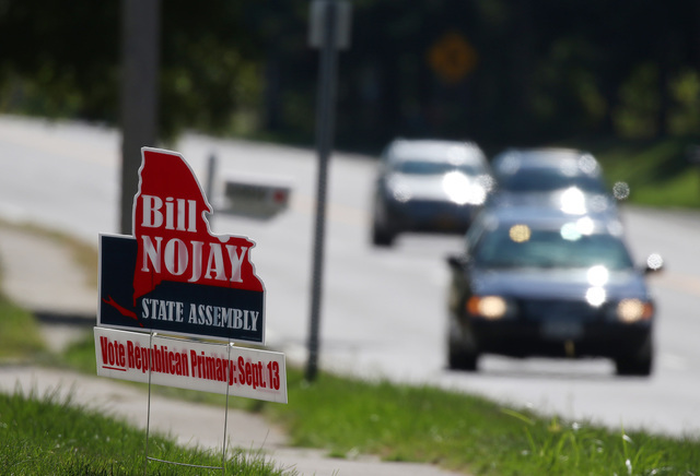 A sign supporting deceased Assemblyman Bill Nojay, who was seeking re-election, sits on Monroe Avenue near French Road on Tuesday, Sept. 13, 2016, in Pittsford, N.Y. (Tina MacIntyre-Yee/AP)