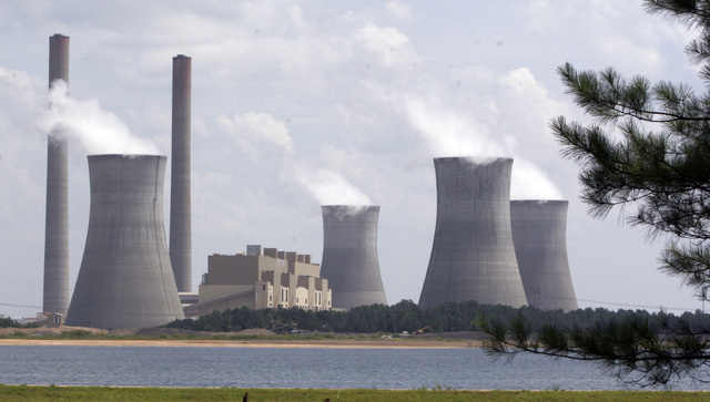 The coal-fired Plant Scherer is in operation at Juliette, Georgia. According to a poll, most Americans are willing to pay a little more each month to fight global warming, but only a tiny bit. (Ge ...