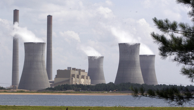 The coal-fired Plant Scherer is in operation at Juliette, Georgia. According to a poll, most Americans are willing to pay a little more each month to fight global warming, but only a tiny bit. (Ge ...