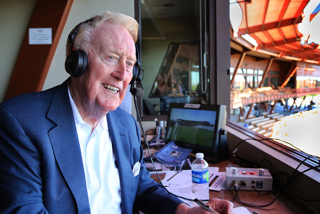 In this March 25, 2016, file photo, Los Angeles Dodgers broadcaster Vin Scully sits in the booth at the ballpark in Glendale, Ariz., for a spring training baseball game. Scully says the last ballg ...